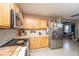 Well-lit kitchen with wood cabinetry, stainless-steel appliances, and neutral countertops at 5088 Thornton Dr, Summerville, SC 29485