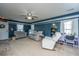 Bright living room features neutral carpet, a ceiling fan and comfortable seating at 5088 Thornton Dr, Summerville, SC 29485