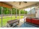 Screened porch with wood furniture, a ceiling fan, and view of the fenced backyard at 5088 Thornton Dr, Summerville, SC 29485