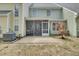 Back exterior featuring a screened-in porch, patio, and well-maintained siding at 522 Tayrn Dr, Wando, SC 29492