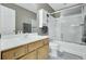 Bathroom with a white sink, wood cabinets and a shower and tub combination with sliding doors at 522 Tayrn Dr, Wando, SC 29492