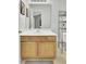 Well-lit bathroom with a wide mirror, natural wood vanity, and plenty of storage space for a convenient design at 522 Tayrn Dr, Wando, SC 29492