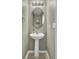 Elegant powder room featuring a pedestal sink, oval mirror, and neutral wall color providing a clean and simple design at 522 Tayrn Dr, Wando, SC 29492