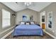 Inviting bedroom featuring a blue quilt on the bed, with ensuite access, and plenty of natural light from the window at 522 Tayrn Dr, Wando, SC 29492