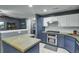 Modern kitchen with concrete countertops, stainless steel appliances, and two-tone cabinetry at 522 Tayrn Dr, Wando, SC 29492