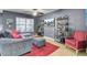 Comfortable living room featuring gray walls, a large gray sofa, and a bright red rug for a cozy and modern feel at 522 Tayrn Dr, Wando, SC 29492