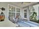 Cozy screened porch with comfortable seating, ceiling fan, and good lighting perfect for relaxation and outdoor enjoyment at 522 Tayrn Dr, Wando, SC 29492