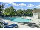 Community swimming pool surrounded by lounge chairs and lush trees, offering a relaxing atmosphere at 522 Tayrn Dr, Wando, SC 29492