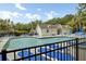 Community pool surrounded by lounge chairs and bordered with wrought iron fencing at 522 Tayrn Dr, Wando, SC 29492