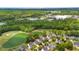 Aerial view of a golf course community with a pond surrounded by trees and homes at 5258 Mulholland Dr, Summerville, SC 29485