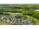 Aerial of a neighborhood near a pond and golf course surrounded by mature trees and greenery at 5258 Mulholland Dr, Summerville, SC 29485