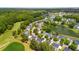 Aerial view of homes nestled beside a lush green golf course with tranquil ponds at 5258 Mulholland Dr, Summerville, SC 29485
