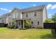 Expansive backyard featuring lush green grass, a screened porch, and ample space for outdoor activities at 5258 Mulholland Dr, Summerville, SC 29485