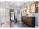 Bright bathroom featuring a double vanity, large mirror, and herringbone tile floors at 5258 Mulholland Dr, Summerville, SC 29485