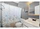 Clean bathroom features a shower with a floral curtain, white vanity, large mirror, and gray walls at 5258 Mulholland Dr, Summerville, SC 29485