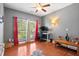 The bedroom features gray walls, red curtains, a ceiling fan, and hardwood floors, providing a comfortable living space at 5258 Mulholland Dr, Summerville, SC 29485