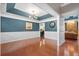 Elegant dining area with hardwood floors, teal walls, and a modern chandelier, open to the kitchen at 5258 Mulholland Dr, Summerville, SC 29485