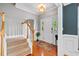 Warm and inviting foyer with beautiful hardwood floors, a staircase, and a charming front door with sidelights at 5258 Mulholland Dr, Summerville, SC 29485