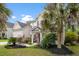 Attractive two-story home with lush landscaping, vibrant plants, and a welcoming front entrance, creating a warm curb appeal at 5258 Mulholland Dr, Summerville, SC 29485
