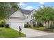 Inviting two-story home featuring an attached garage, a well-maintained lawn, and a charming entrance at 5258 Mulholland Dr, Summerville, SC 29485