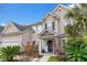 Charming two-story home showcasing a manicured lawn, complemented by lush landscaping and a welcoming front entrance at 5258 Mulholland Dr, Summerville, SC 29485