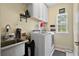 Functional laundry room with sink, washer, dryer, cabinets, and natural light at 5258 Mulholland Dr, Summerville, SC 29485