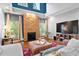 Inviting living room with a stone fireplace, tall ceilings, and large windows at 5258 Mulholland Dr, Summerville, SC 29485