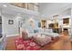 Open-concept living room with second-story balcony and view to the kitchen at 5258 Mulholland Dr, Summerville, SC 29485