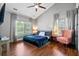 The spacious main bedroom has two large windows, a ceiling fan, and hardwood floors, providing a serene retreat at 5258 Mulholland Dr, Summerville, SC 29485