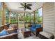 Comfortable screened porch features a ceiling fan, and stylish wicker furniture at 5258 Mulholland Dr, Summerville, SC 29485