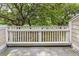 An outdoor balcony with a white railing overlooking greenery and surrounding trees at 55 Fairway Dunes Ln, Isle of Palms, SC 29451