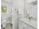 Neutral bathroom featuring granite counters, a window overlooking greenery, and white cabinets at 55 Fairway Dunes Ln, Isle of Palms, SC 29451