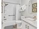 Bright bathroom with white cabinets, granite counters, a shower/bath combo, and nice tile at 55 Fairway Dunes Ln, Isle of Palms, SC 29451