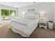 Beautiful primary bedroom with king bed, a balcony, white walls, and lovely natural light at 55 Fairway Dunes Ln, Isle of Palms, SC 29451