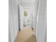 Hallway view featuring storage closets, and a bathroom with white cabinets and neutral walls at 55 Fairway Dunes Ln, Isle of Palms, SC 29451