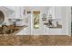 Well-lit kitchen featuring white cabinets, granite countertops, and stainless steel appliances at 55 Fairway Dunes Ln, Isle of Palms, SC 29451