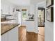 Bright kitchen features white cabinets, granite counters, and hardwood floors at 55 Fairway Dunes Ln, Isle of Palms, SC 29451