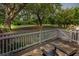 Serene patio with views of the lush green space and mature trees at 55 Fairway Dunes Ln, Isle of Palms, SC 29451