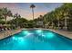 Resort-style community pool with lounge chairs surrounded by mature palm trees at 55 Fairway Dunes Ln, Isle of Palms, SC 29451
