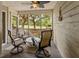 Relaxing screened porch with comfortable seating and views of the green landscape at 55 Fairway Dunes Ln, Isle of Palms, SC 29451