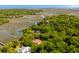 Stunning aerial view of a waterfront property surrounded by lush greenery and a winding river at 554 Parrot Point Dr, Charleston, SC 29412