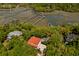 Stunning aerial view of a home nestled among lush trees, overlooking the serene waterways and marshes at 554 Parrot Point Dr, Charleston, SC 29412
