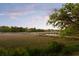 Picturesque marsh view with a dock, gazebo, and boat lift at 554 Parrot Point Dr, Charleston, SC 29412