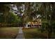 Beautiful backyard view with string lights, lush landscaping, and a glimpse of the charming home exterior at 554 Parrot Point Dr, Charleston, SC 29412