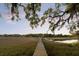 Picturesque marsh view with a long dock, gazebo, and boat lift under a stunning sky at 554 Parrot Point Dr, Charleston, SC 29412