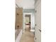 Bathroom featuring tile flooring, a tub, and access to the Primary bedroom with natural light at 554 Parrot Point Dr, Charleston, SC 29412