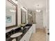Bright bathroom featuring double vanity, shiplap walls, and walk-in shower at 554 Parrot Point Dr, Charleston, SC 29412