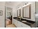 Elegant bathroom featuring double sinks, granite countertops, and shiplap walls at 554 Parrot Point Dr, Charleston, SC 29412