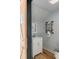 Charming bathroom featuring stylish vanity, industrial shelving and wood look floors at 554 Parrot Point Dr, Charleston, SC 29412