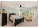 Inviting bedroom with natural light, seating area, a ceiling fan, and neutral tones offers cozy comfort at 554 Parrot Point Dr, Charleston, SC 29412
